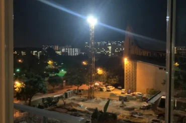 Flood lights late night construction works affecting apartment residents