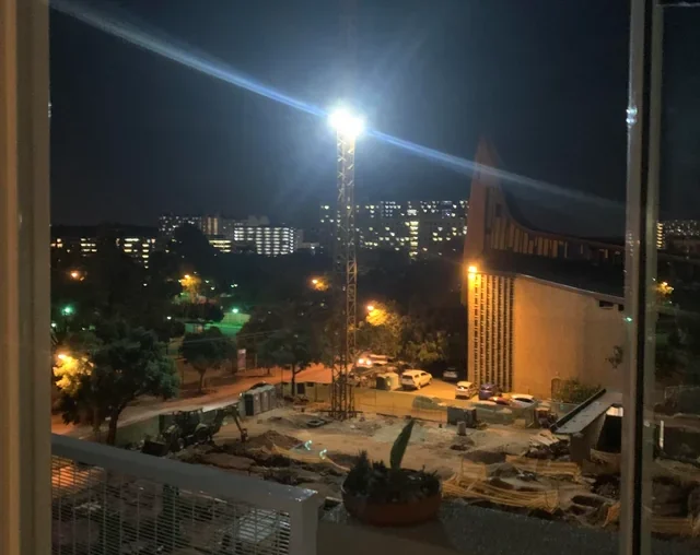 Flood lights late night construction works affecting apartment residents